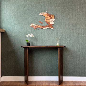 Haiti wood wall map above a tall console table, wide room view with white baseboard