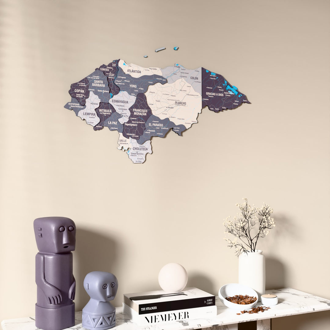 Nimbus Honduras wooden wall map on a beige wall above a console with figurines