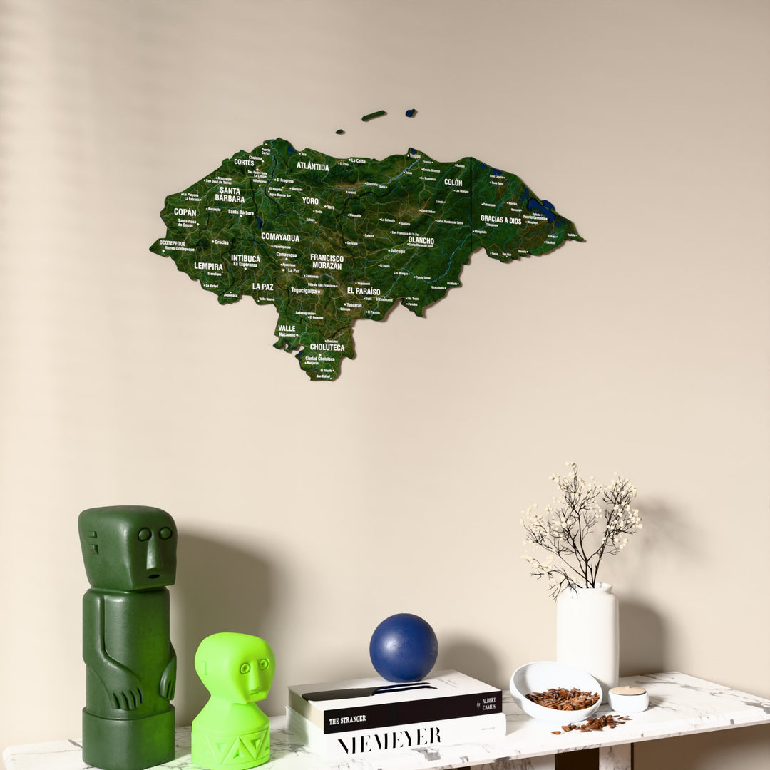 Satellite Honduras wooden wall map on a beige wall above a console with figurines
