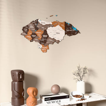 Soil Honduras wooden wall map on a beige wall above a console with figurines
