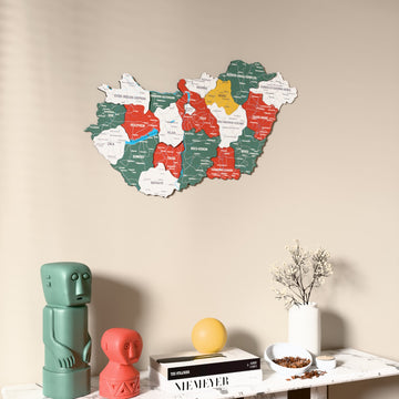 Flag colored Hungary wooden wall map on a beige wall above a console with figurines