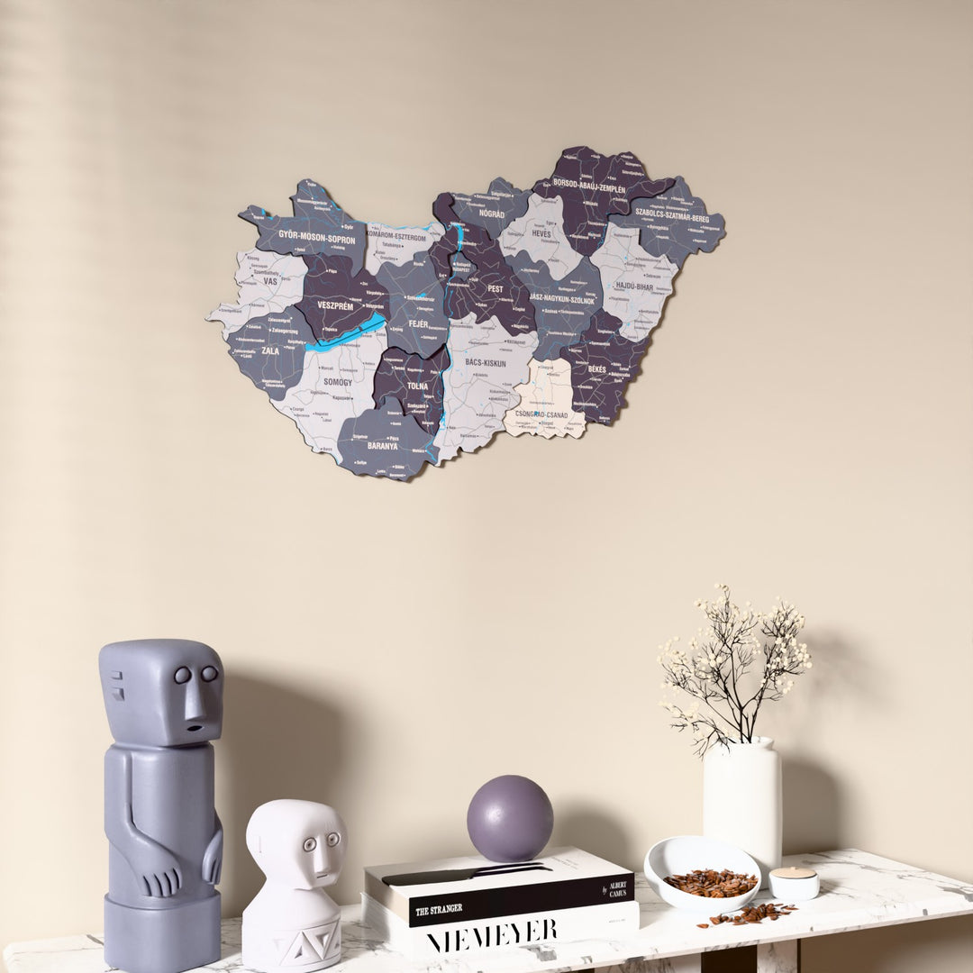 Nimbus Hungary wooden wall map on a beige wall above a console with figurines
