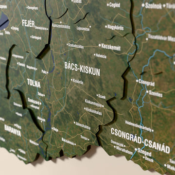 Close-up of the Satellite Hungary wooden wall map with layered regions and printed names