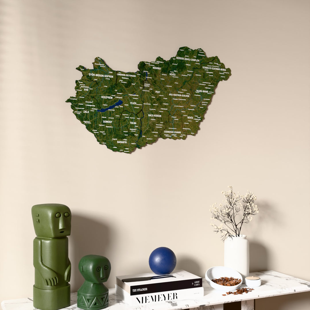 Satellite Hungary wooden wall map on a beige wall above a console with figurines