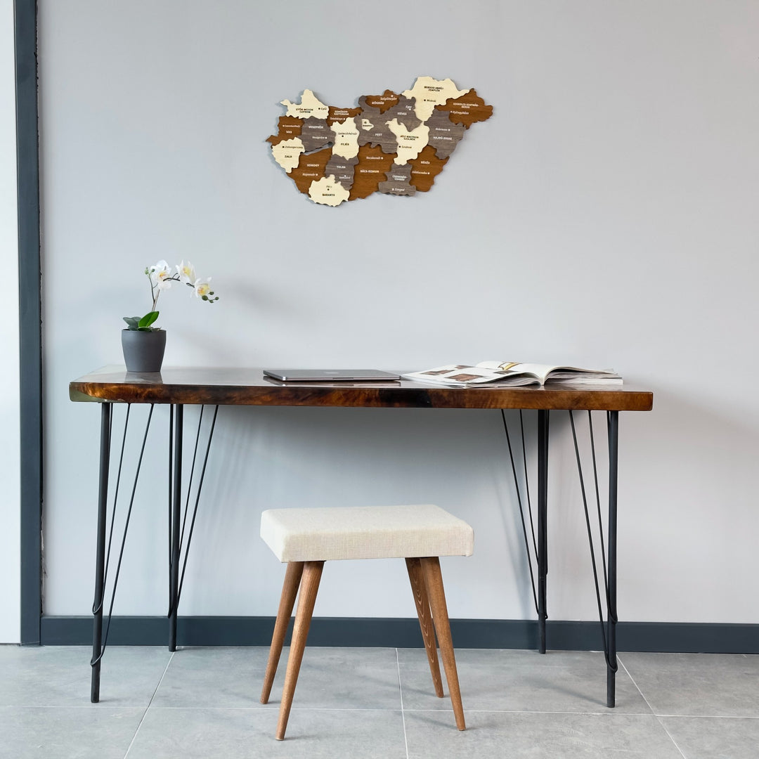 Wooden Hungary map high on a gray wall above a console desk and white stool