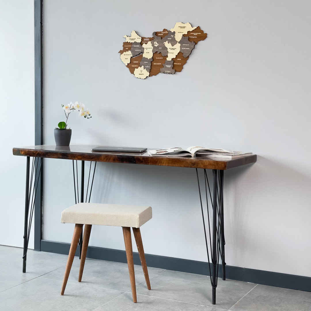 Wooden Hungary map above a hairpin-leg desk and stool, view from a lower angle