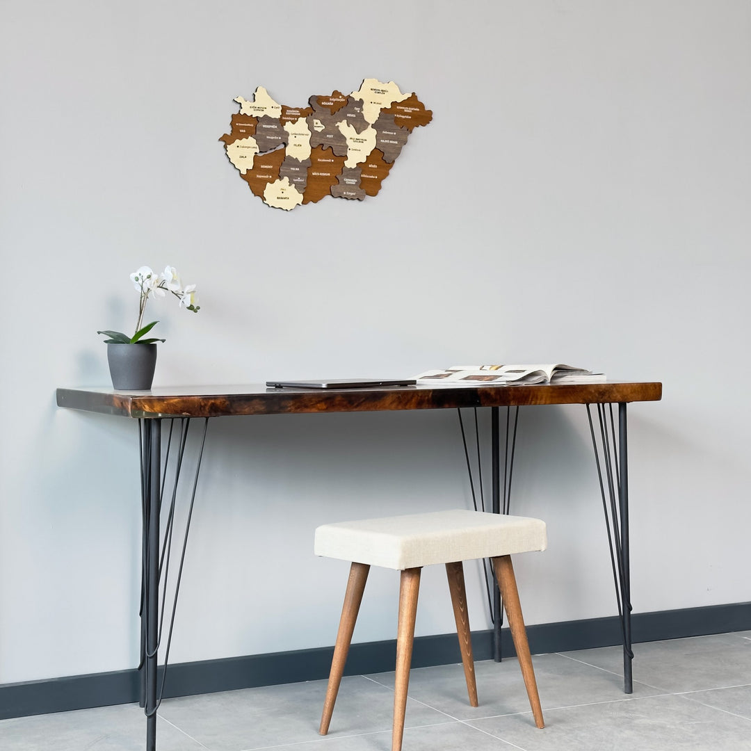 Wooden Hungary map above a narrow desk with a stool, wide view of the wall