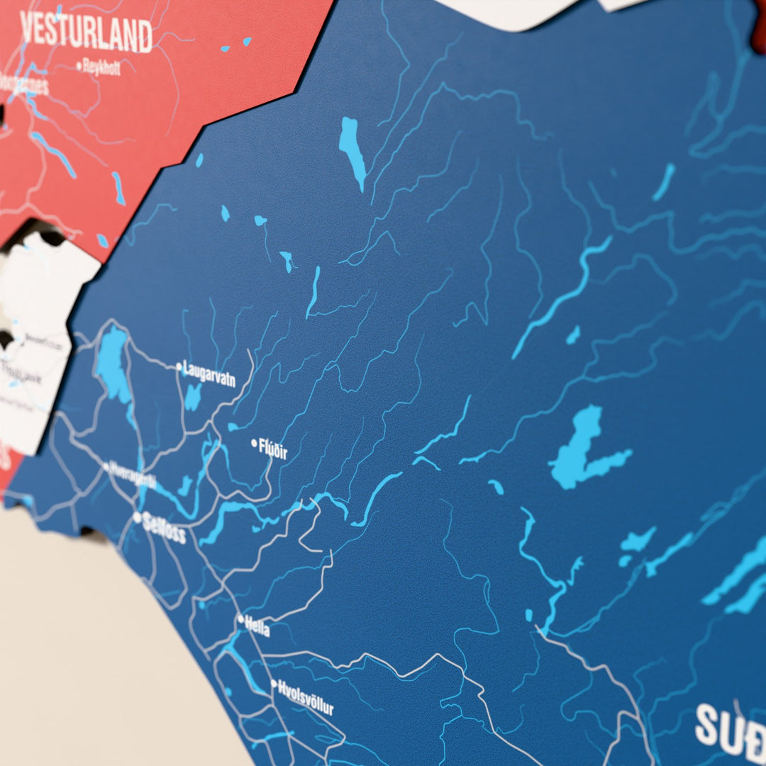 Close-up of the Flag colored Iceland wooden wall map with layered regions and printed names