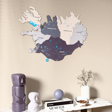 Nimbus Iceland wooden wall map on a beige wall above a console with figurines