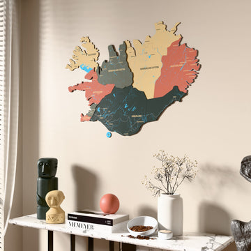 Sage Iceland wooden wall map beside a sheer curtain, angled view
