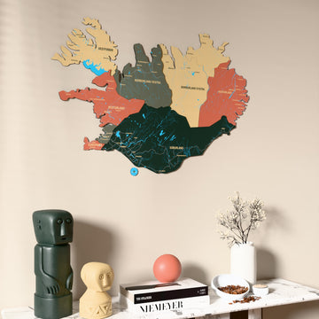 Sage Iceland wooden wall map on a beige wall above a console with figurines