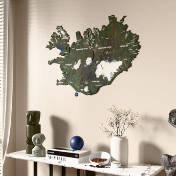 Satellite Iceland wooden wall map beside a sheer curtain, angled view