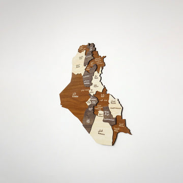 Small wooden Iraq map in brown and light wood, seen from a slight angle on a white wall