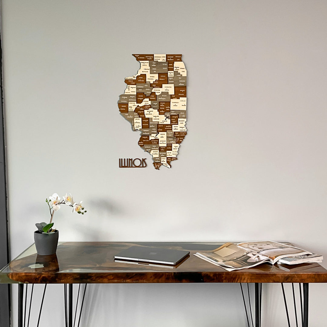 Wooden Illinois state map centered on the wall above a walnut desk with a laptop