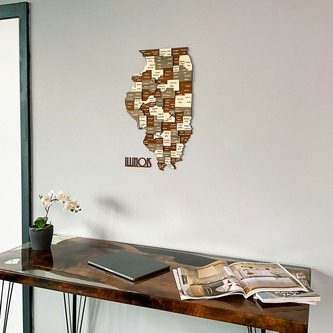 Wooden Illinois county map with state name piece, angled low view above a desk with a magazine