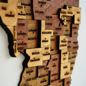 Angled close-up of the wooden Illinois map showing Madison, Montgomery and St. Clair county layers