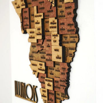 Side close-up of the southern Illinois wooden map with stacked county pieces and ILLINOIS lettering at the edge