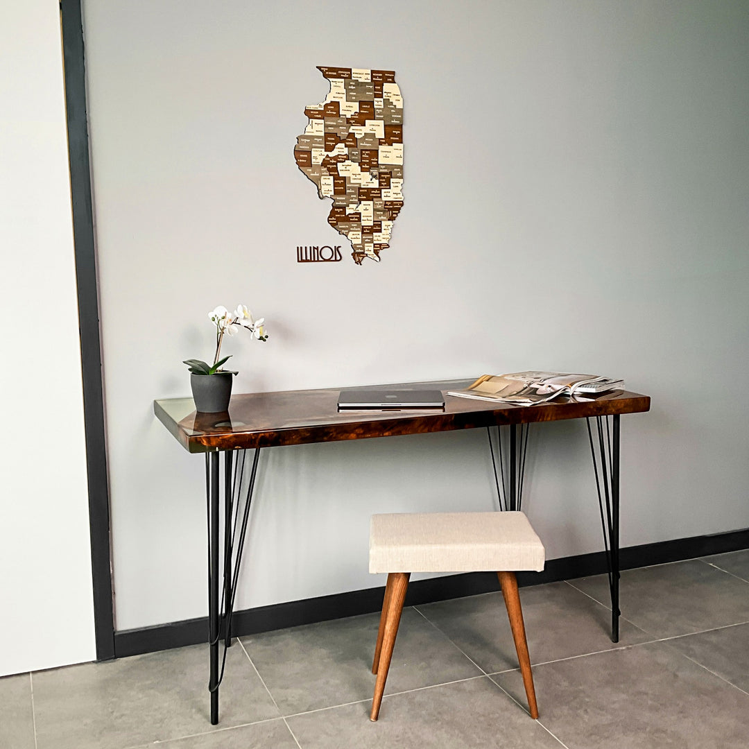 Wide room view with the multicolor wooden Illinois map above a desk and an orchid at left