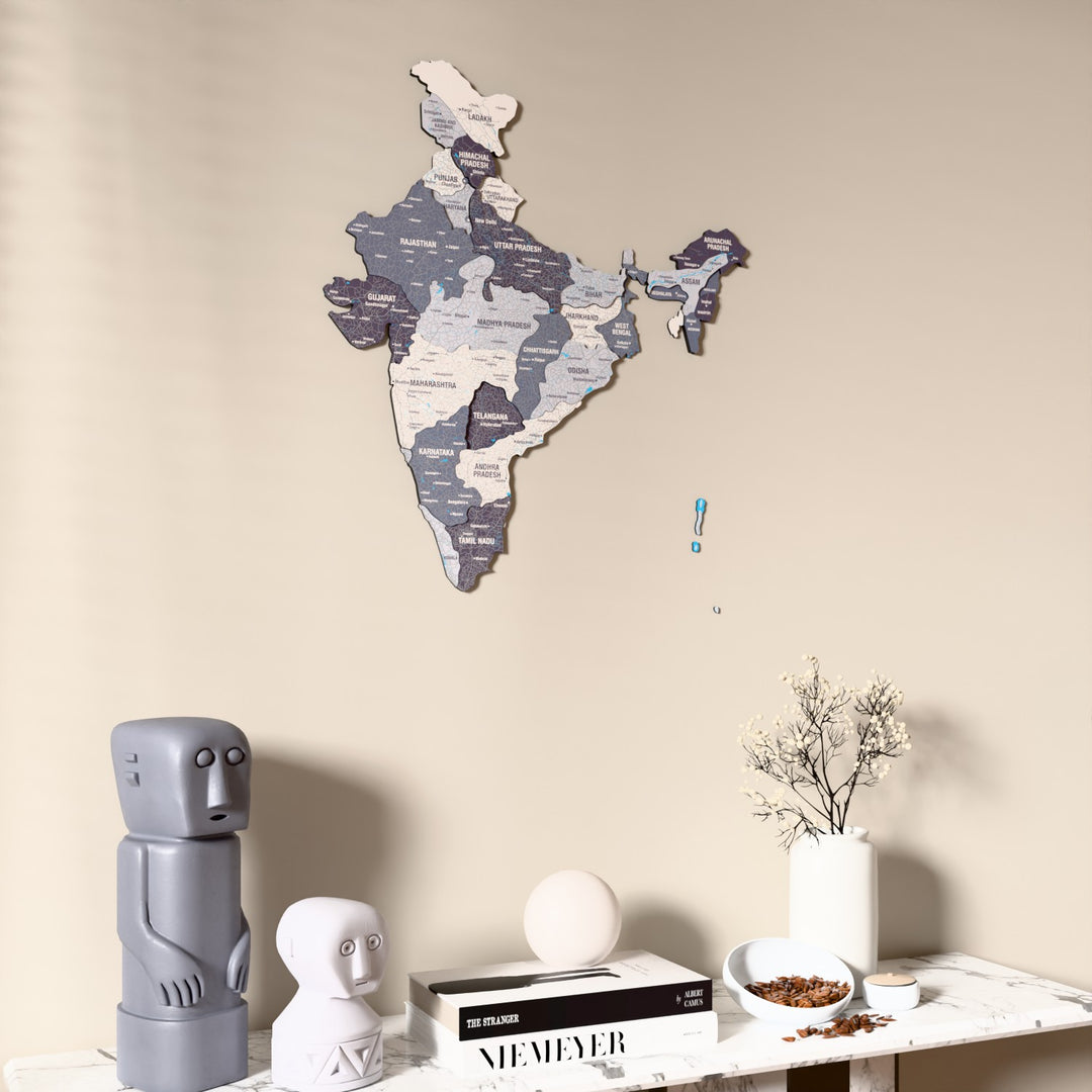 Nimbus India wooden wall map on a beige wall above a console with figurines