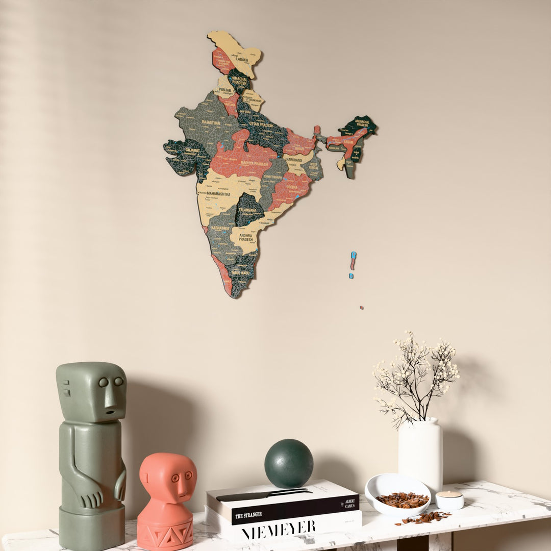 Sage India wooden wall map on a beige wall above a console with figurines