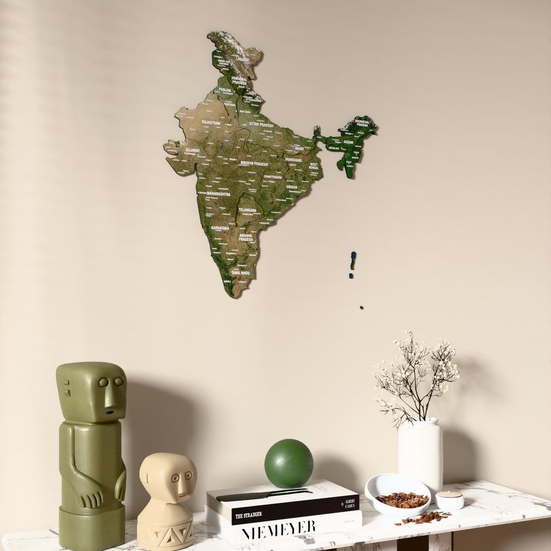 Satellite India wooden wall map on a beige wall above a console with figurines