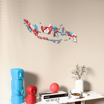 Flag colored Indonesia wooden wall map on a beige wall above a console with figurines