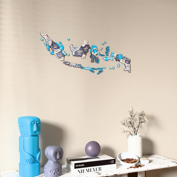 Nimbus Indonesia wooden wall map on a beige wall above a console with figurines