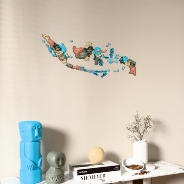 Sage Indonesia wooden wall map on a beige wall above a console with figurines
