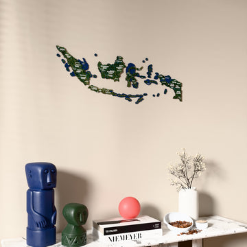 Satellite Indonesia wooden wall map on a beige wall above a console with figurines