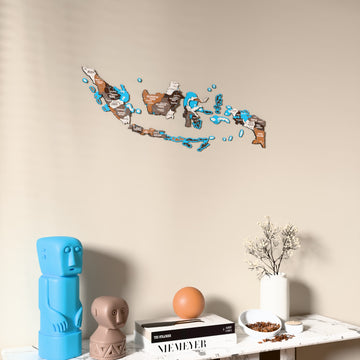 Soil Indonesia wooden wall map on a beige wall above a console with figurines