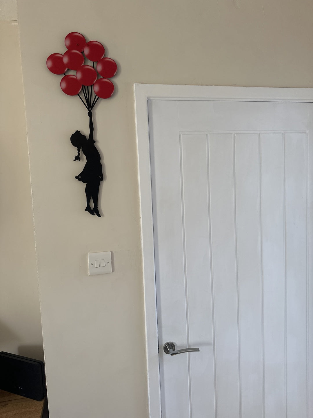 Banksy Metal Wall Art: Girl with Balloons Entryway Wall Decor in a customer's home