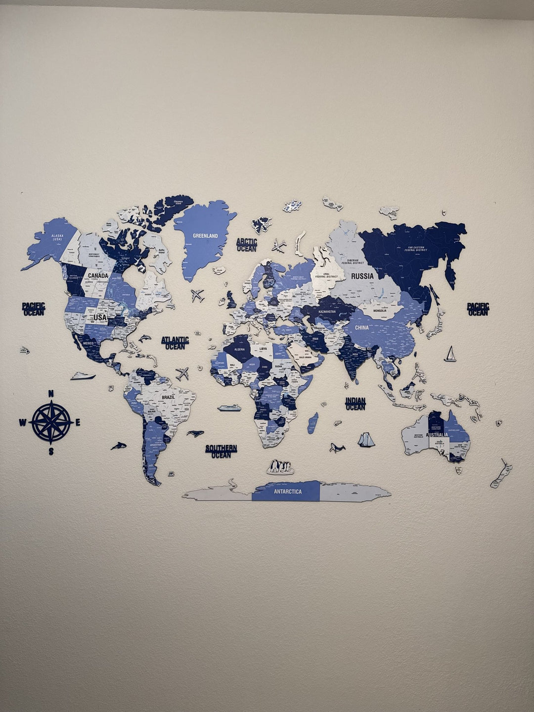 Wooden World Map with Pins - 3D & Vibrant Colors (Navy) in a customer's home