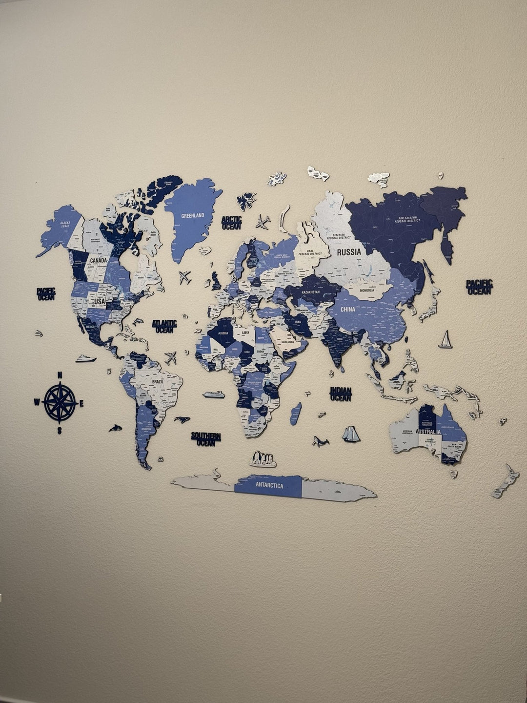 Wooden World Map with Pins - 3D & Vibrant Colors (Navy) in a customer's home