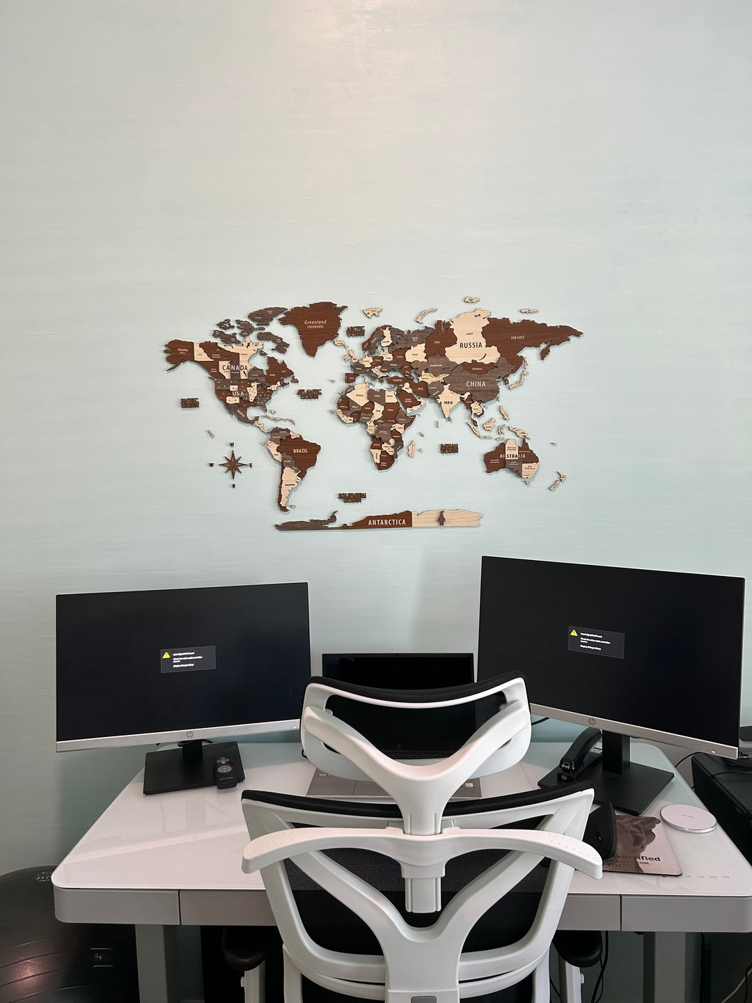 Wooden World Map Wall Art - 3d Wood Push Pin Maps, Multicolor in a customer's home
