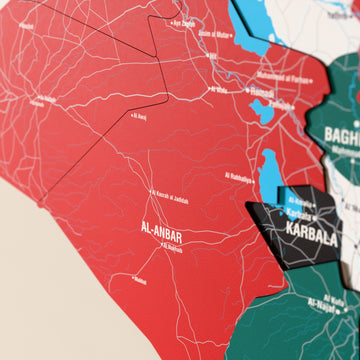 Close-up of the Flag colored Iraq wooden wall map with layered regions and printed names