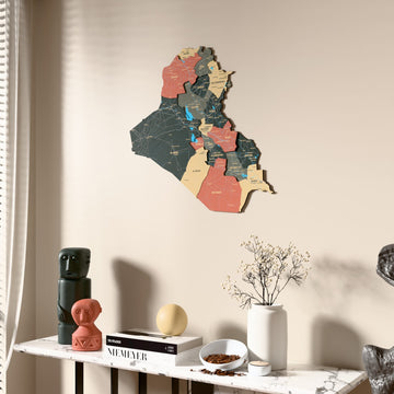 Sage Iraq wooden wall map beside a sheer curtain, angled view