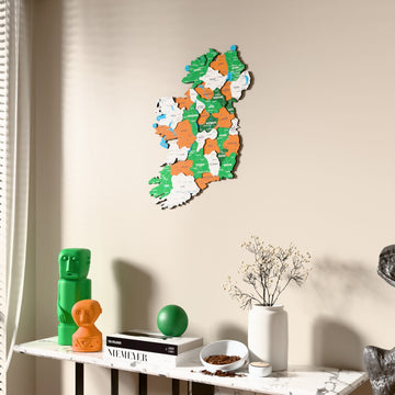 Flag colored Ireland wooden wall map beside a sheer curtain, angled view