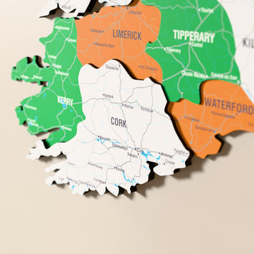Close-up of the Flag colored Ireland wooden wall map with layered regions and printed names
