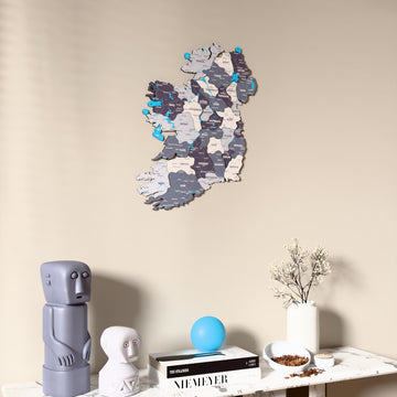Nimbus Ireland wooden wall map on a beige wall above a console with figurines