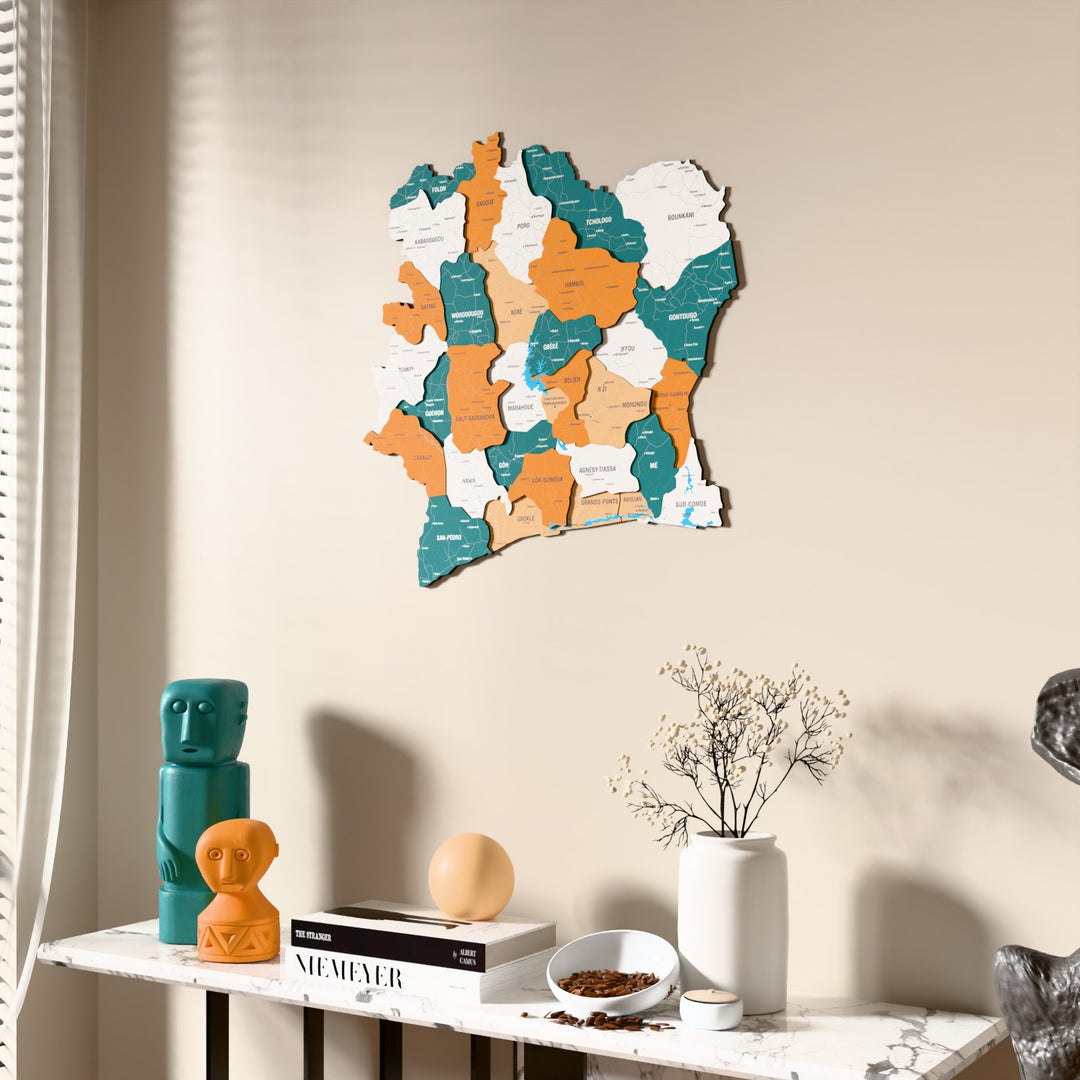 Flag colored Ivory Coast wooden wall map beside a sheer curtain, angled view