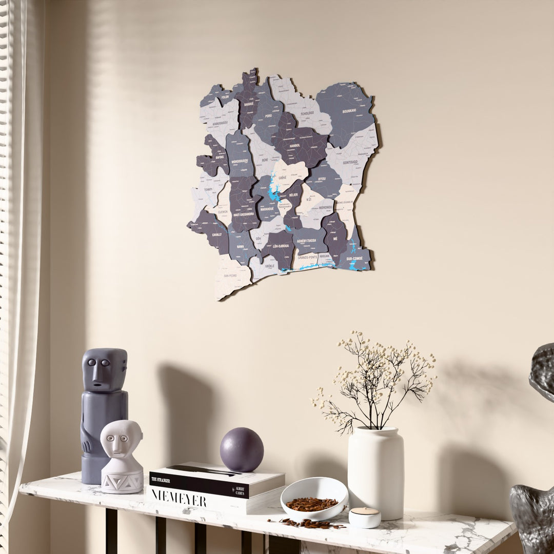 Nimbus Ivory Coast wooden wall map beside a sheer curtain, angled view