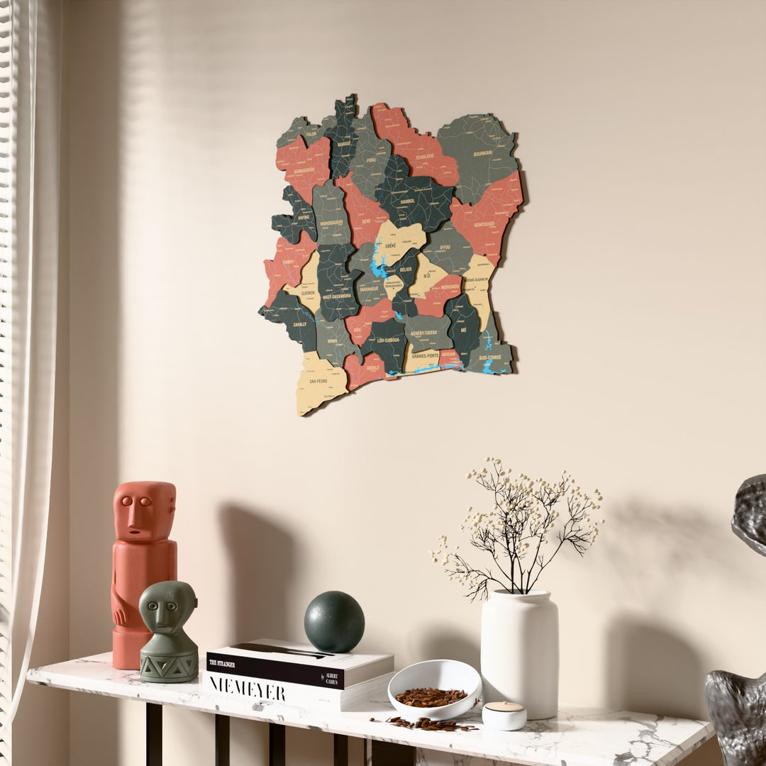 Sage Ivory Coast wooden wall map beside a sheer curtain, angled view