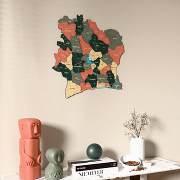Sage Ivory Coast wooden wall map on a beige wall above a console with figurines