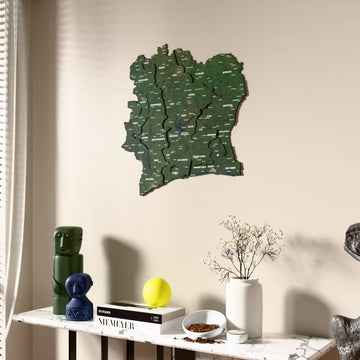 Satellite Ivory Coast wooden wall map beside a sheer curtain, angled view