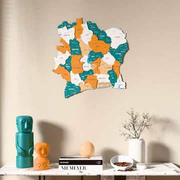Flag colored Ivory Coast wooden wall map above a marble console, front view