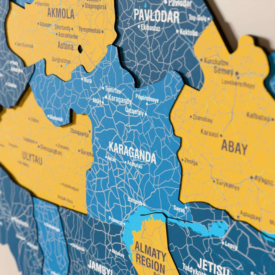 Close-up of the Flag colored Kazakhstan wooden wall map with layered regions and printed names