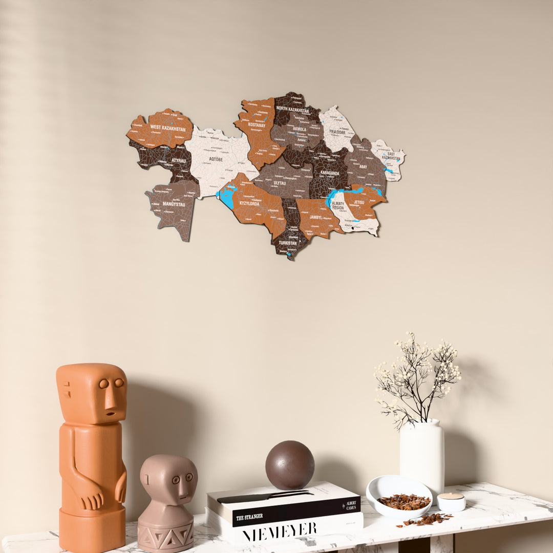 Soil Kazakhstan wooden wall map on a beige wall above a console with figurines
