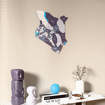 Nimbus Kenya wooden wall map on a beige wall above a console with figurines