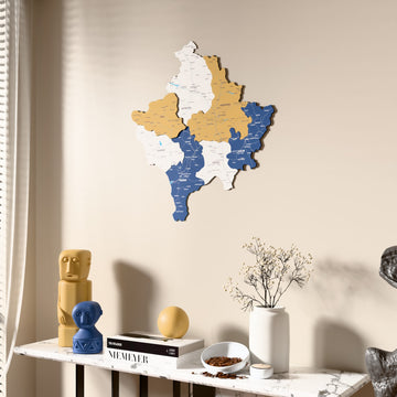 Flag colored Kosovo wooden wall map beside a sheer curtain, angled view