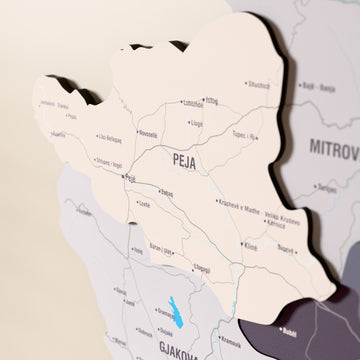 Close-up of the Nimbus Kosovo wooden wall map with layered regions and printed names